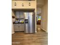 Modern kitchen featuring stainless steel refrigerator, ample counter space, and a view of the living room at 8541 W Rosemonte Dr, Peoria, AZ 85382