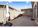 Back patio with an umbrella, lush greenery, and privacy fence at 1310 S Pima -- # 35, Mesa, AZ 85210