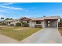 Pleasant single-story home featuring a well-kept lawn and attached carport at 1324 W 15Th St, Tempe, AZ 85281