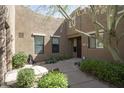 Home's entrance featuring a beautiful walkway, desert landscaping, and elegant front door at 13300 E Via Linda -- # 2057, Scottsdale, AZ 85259