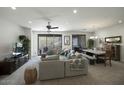 Spacious living room open to the dining area with a ceiling fan and sliding glass doors to the patio at 13300 E Via Linda -- # 2057, Scottsdale, AZ 85259