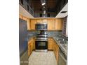 Galley kitchen featuring granite counters, stainless appliances and mosaic tile backsplash at 1331 W Baseline Rd # 152, Mesa, AZ 85202