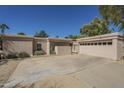 Close up of the exterior elevation featuring desert landscaping and an attached garage at 14266 N 2Nd Ave, Phoenix, AZ 85023