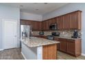 Well-appointed kitchen featuring granite countertops, stainless steel appliances, and wood cabinetry at 16492 N 181St Dr, Surprise, AZ 85388