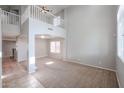 Bright living room with vaulted ceilings, large windows and neutral color scheme at 17474 W Acapulco Ln, Surprise, AZ 85388