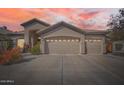 Stunning home showcasing an oversized three car garage as dusk begins to fall at 1966 E Drake Dr, Tempe, AZ 85283