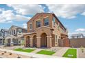 Inviting two-story house showing landscaped front, covered entry with archways and new turf at 26029 N 23Rd Ave, Phoenix, AZ 85085