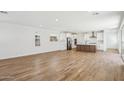 Bright, open-concept living space features beautiful wood flooring and abundant natural light at 26029 N 23Rd Ave, Phoenix, AZ 85085