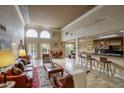 Elegant living room with tile floors, bar, and seamless open floor plan at 2637 E Beekman Pl, Phoenix, AZ 85016