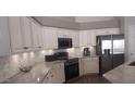 Beautiful kitchen with stainless appliances, white cabinets, and a marble backsplash at 2851 N Ricardo --, Mesa, AZ 85215