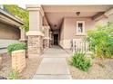 Inviting front porch with stone columns, neutral paint, and decorative landscaping at 34916 N 31St Ave, Phoenix, AZ 85086