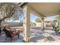 Covered patio with chairs and table, leading to a spacious backyard at 4033 E Wildcat Dr, Cave Creek, AZ 85331