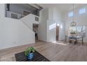 Open-concept living area with high ceilings, clerestory windows, wood flooring, a staircase, and views into other rooms at 4033 E Wildcat Dr, Cave Creek, AZ 85331