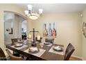 Elegant dining room features a large wood table with seating for six and stylish overhead lighting at 5439 N Ormondo Way, Litchfield Park, AZ 85340