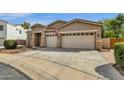 Wide driveway leading to a well-maintained beige home with a three-car garage and stone accents at 6271 S Twilight Ct, Gilbert, AZ 85298