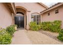 Inviting front entrance with a dark double door, and desert landscaping at 9126 E Topeka Dr, Scottsdale, AZ 85255