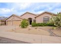 Attractive single-story home with xeriscape landscaping and a barrel tile roof at 9126 E Topeka Dr, Scottsdale, AZ 85255