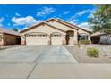 Spacious home with a three-car garage, extended driveway, and low-maintenance desert landscaping at 9174 W Marconi Ave, Peoria, AZ 85382