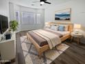 Comfortable bedroom featuring a ceiling fan, a plush rug and a decorative accent wall at 10320 W Cashman Dr, Peoria, AZ 85383