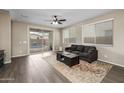 Bright living room features modern flooring, a ceiling fan, a large sliding glass door and ample sunlight at 10617 E Durant Dr, Mesa, AZ 85212