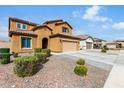 Charming two-story home featuring a terracotta roof, yellow stucco, and a two-car garage at 10816 W Nosean Rd, Peoria, AZ 85383