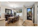 Bright dining room showcasing tile floors, a large window, and stylish dining set at 11496 E Pine Valley Rd, Scottsdale, AZ 85255