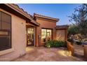 Charming home exterior featuring a decorative front door, tiled entryway, and desert landscaping at 11496 E Pine Valley Rd, Scottsdale, AZ 85255