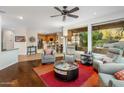 Spacious living room with hardwood floors, a ceiling fan, and a view of the backyard at 11496 E Pine Valley Rd, Scottsdale, AZ 85255