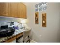 Home office features built-in cabinetry, granite desk top, and wine-themed decor for an efficient workspace at 11640 N Tatum Blvd # 1052, Phoenix, AZ 85028