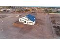 Aerial view of a modern single-Gathering home in a developing neighborhood, boasting a vast, open landscape at 1207 N 362Nd Ave, Tonopah, AZ 85354