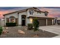 Inviting home exterior showcasing desert landscaping, arched entry, and three car garage at 1252 N Jackson St, Gilbert, AZ 85233