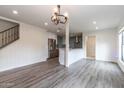 Bright and airy living room open to the modern kitchen featuring sleek gray flooring and recessed lighting at 1327 W Glendale Ave, Phoenix, AZ 85021