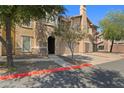 Inviting home exterior with a private garage, stone accents, and neatly maintained landscaping at 14250 W Wigwam Blvd # 1022, Litchfield Park, AZ 85340