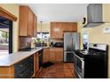 Stylish kitchen featuring stainless steel appliances, warm cabinetry and abundant natural light at 1454 E Flower St, Phoenix, AZ 85014