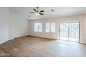 Spacious living room featuring hardwood floors and a sliding glass door at 15853 N 74Th Ave, Peoria, AZ 85382