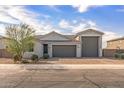 Charming single-story home with a three-car garage and a desert-landscaped front yard at 1627 E Walter Dr, Casa Grande, AZ 85122