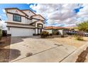 Two-story home with a two-car garage, neutral paint, and desert landscaping at 18316 N Soft Wind Dr, Maricopa, AZ 85138