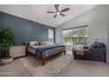 Main bedroom with vaulted ceiling, a large window with neighborhood views, ceiling fan, and ensuite bathroom at 18776 N 90Th Pl, Scottsdale, AZ 85255