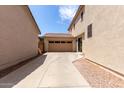 Long driveway between homes leading to a detached two-car garage at 2116 S Moccasin Trl, Gilbert, AZ 85295