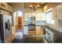 Beautiful kitchen with granite countertops, stainless steel appliances, and white cabinets at 221 E Vaughn Ave, Gilbert, AZ 85234