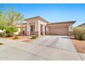 Well-maintained exterior showcasing a large driveway leading to a two-car garage at 22800 E Via Las Brisas Rd, Queen Creek, AZ 85142