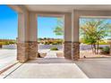 Inviting front porch with neutral brick and desert views at 22800 E Via Las Brisas Rd, Queen Creek, AZ 85142