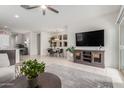 Bright and airy living space with tile floors, ceiling fan, TV, and a combined dining area at 2426 E San Gabriel Trl, Casa Grande, AZ 85194