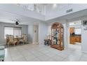 Bright living room with tile floors, high ceilings, and an adjacent dining area at 2501 N 114Th Ave, Avondale, AZ 85392