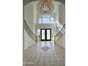 Spacious foyer boasts a chandelier, high ceilings, and double doors with decorative glass at 2868 E Clifton Ct, Gilbert, AZ 85295