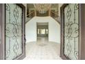 Elegant foyer showcasing a chandelier, tile flooring, and a staircase with wrought iron railings at 2868 E Clifton Ct, Gilbert, AZ 85295