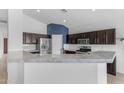 Beautiful kitchen featuring dark wood cabinets, stainless steel appliances, and a spacious marbled countertop at 2882 E Indian Wells Pl, Chandler, AZ 85249