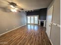 View of living room featuring wood floors, fireplace, ceiling fan and sliding doors at 30 E Brown Rd # 2052, Mesa, AZ 85201