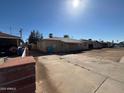 A street view featuring single story homes with long driveways on a sunny day at 3211 W Bethany Home Rd, Phoenix, AZ 85017