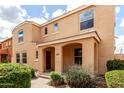 Two-story tan home with covered entry, landscaping, and brick walkway at 3507 E Erie St, Gilbert, AZ 85295